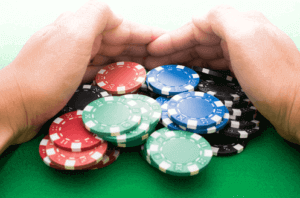 hands pulling in casino chips